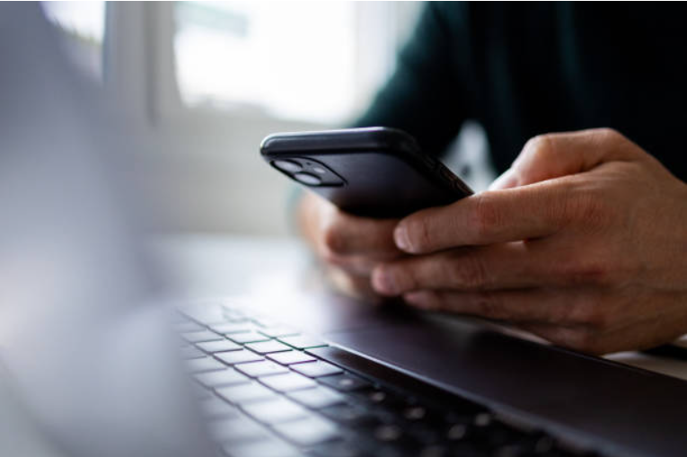 Team members discussing while using a phone